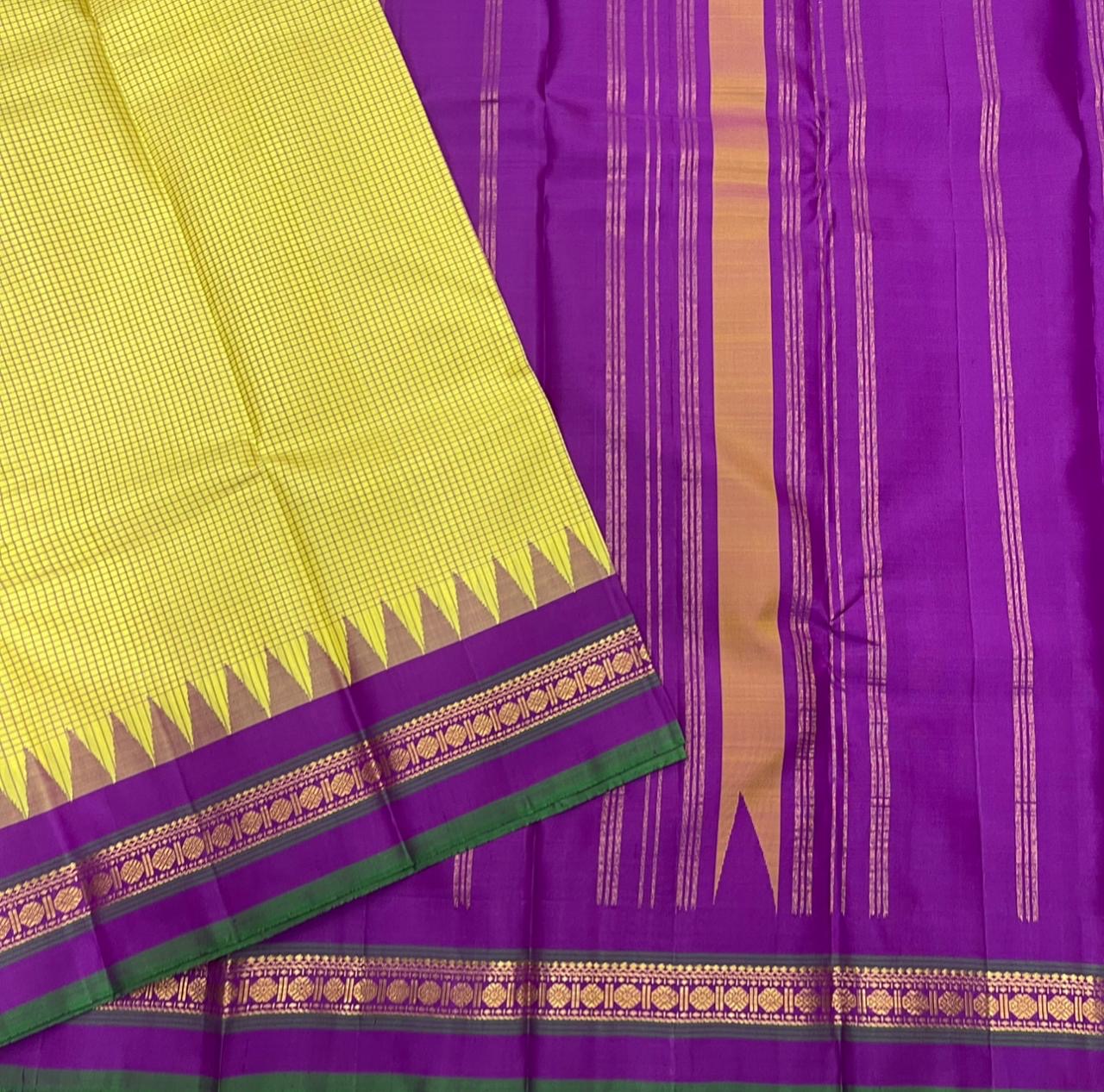 closeup of purple zari woven border with triangular edge detailing and green selvedge on kanchipuram silk saree