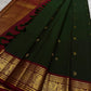 Rain-washed mango-leaf green Kanchipuram body scattered with small classic-gold zari buttas.