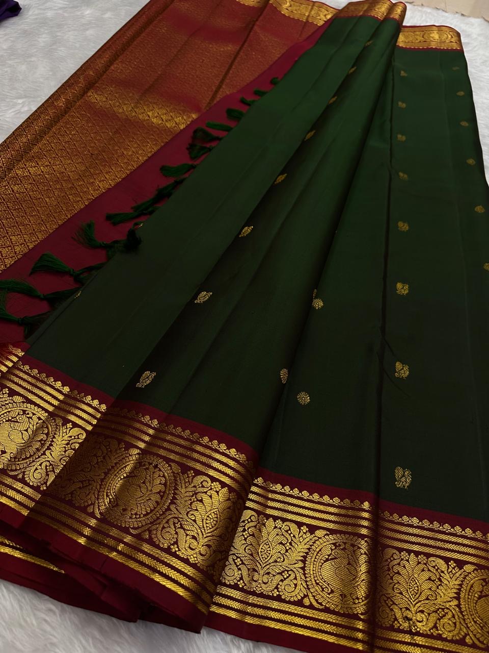 Rain-washed mango-leaf green Kanchipuram body scattered with small classic-gold zari buttas.