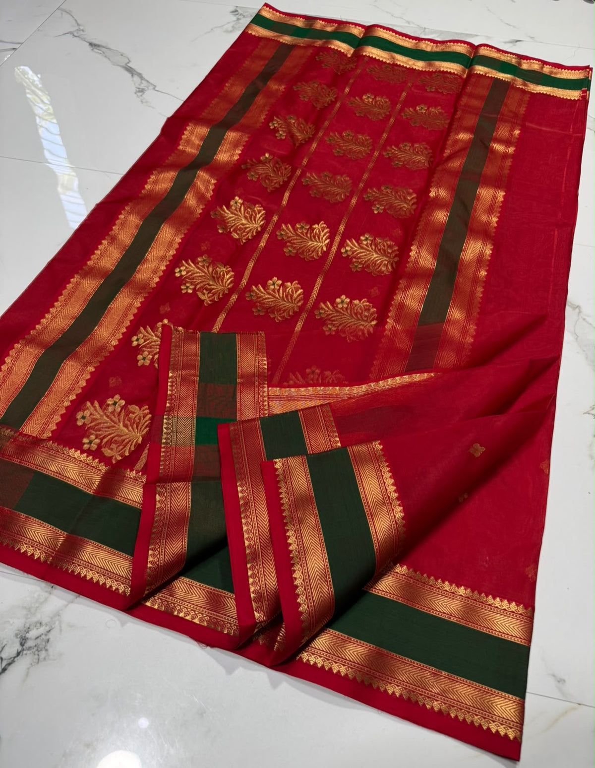 Forest green border with gold zari detail on a crimson red Katan Silk Chanderi saree