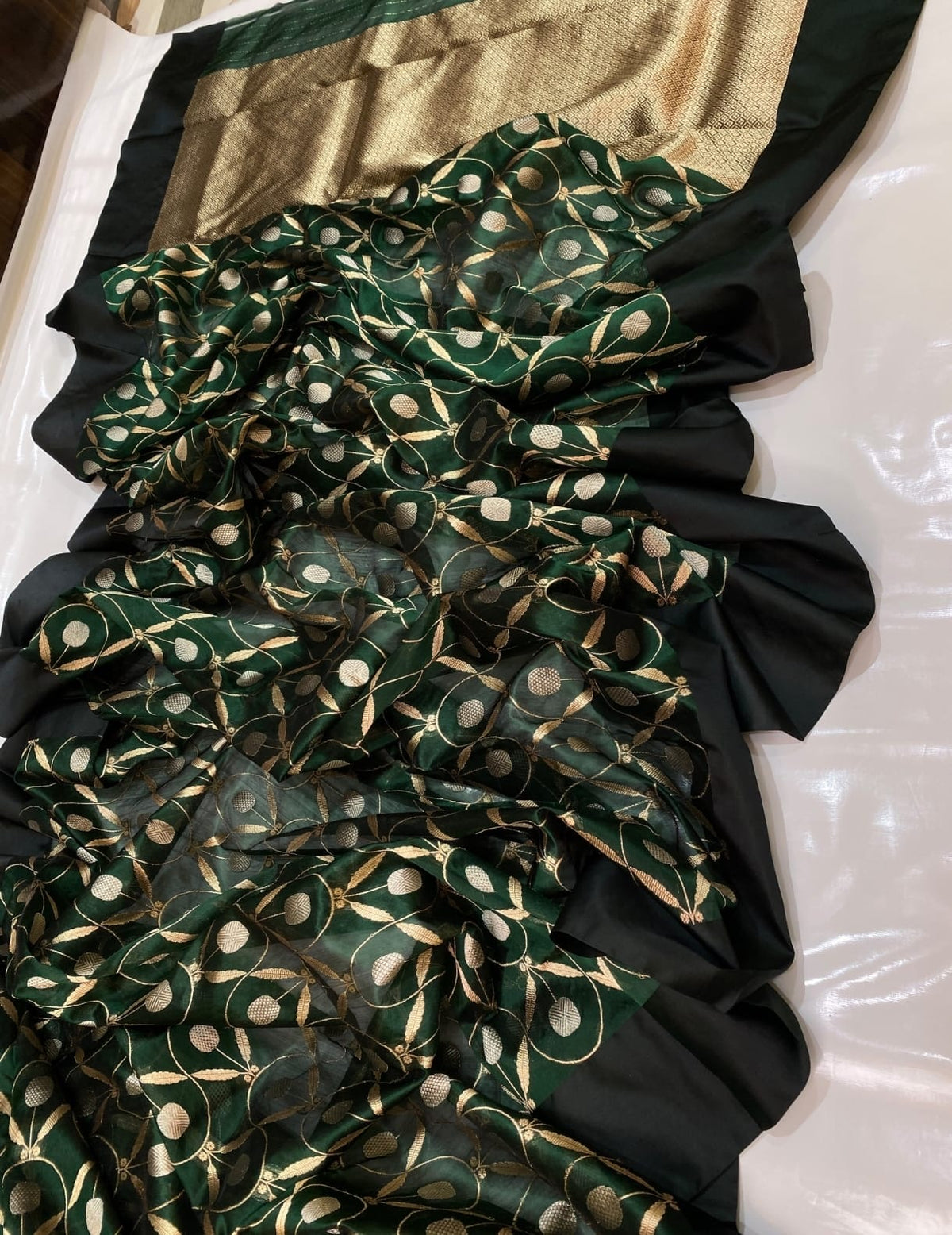 Antique-gold geometric pallu of forest green Chanderi saree