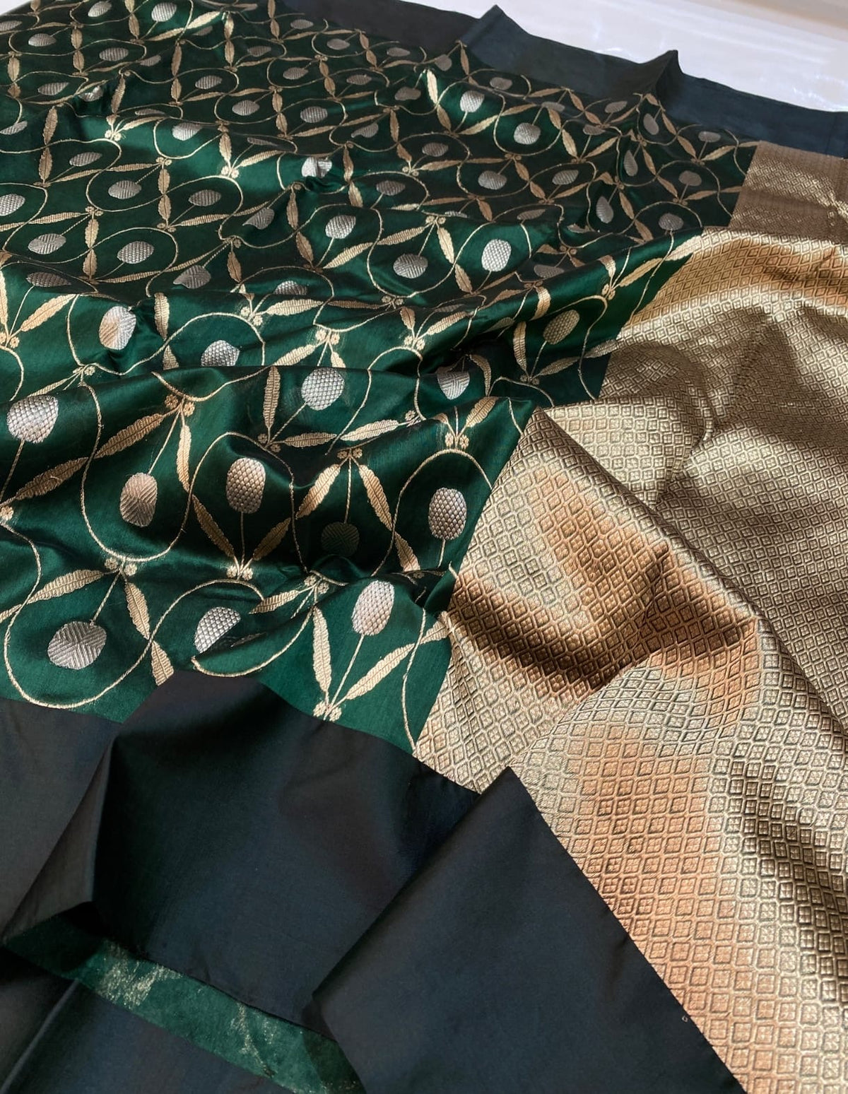Close-up of forest green Chanderi with gold vines and silver motifs