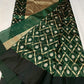 Intricate gold-toned vine and leaf lattice on green silk