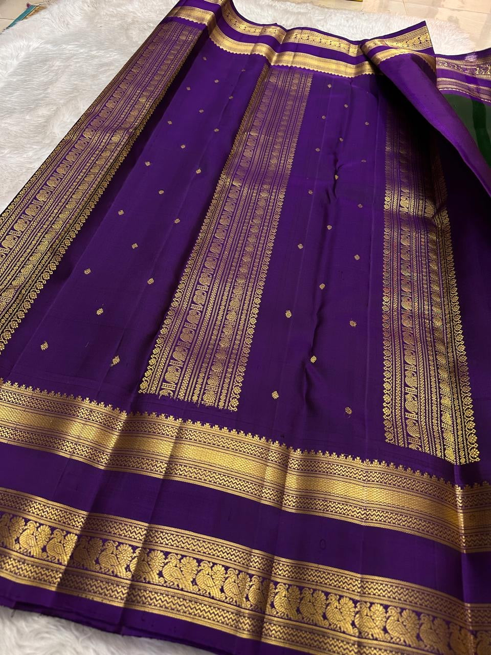 Deep forest green Kanchipuram silk saree with royal violet rettapet border and traditional zari Idam Living