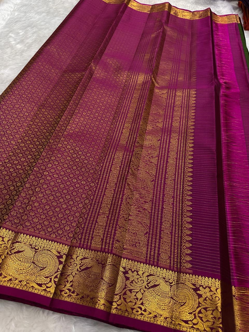 Close-up of gold zari kattam checks on forest green Kanchipuram silk saree