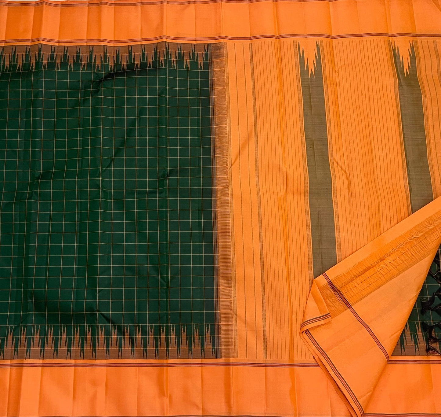 Orange pallu of forest green Kanjipuram pure silk saree with Thazhampoo Reku and Varisaipet antique gold zari cascade