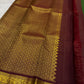 Forest-green Kanchipuram saree with maroon zari border, close view