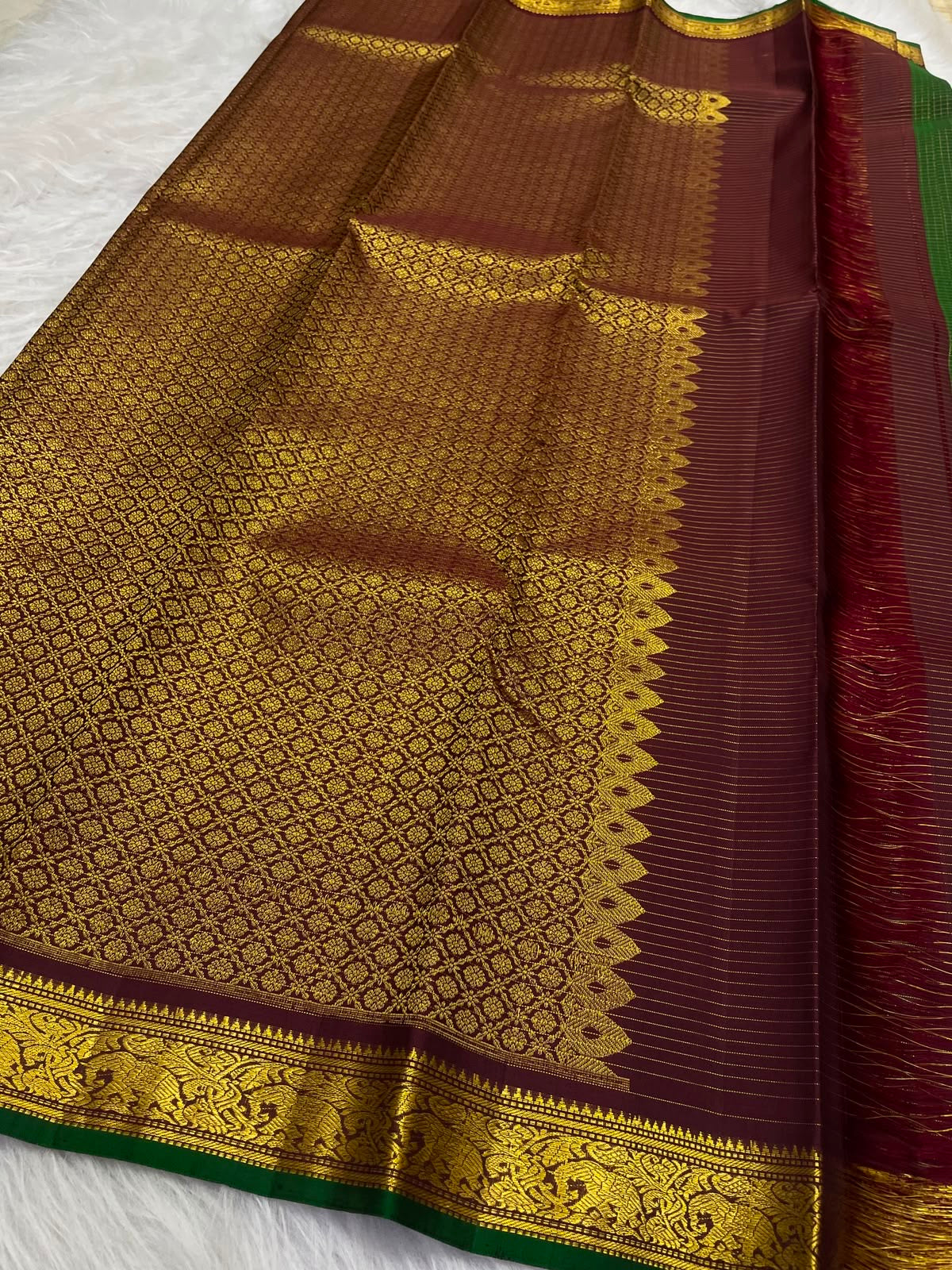 Forest-green Kanchipuram saree with maroon zari border, close view
