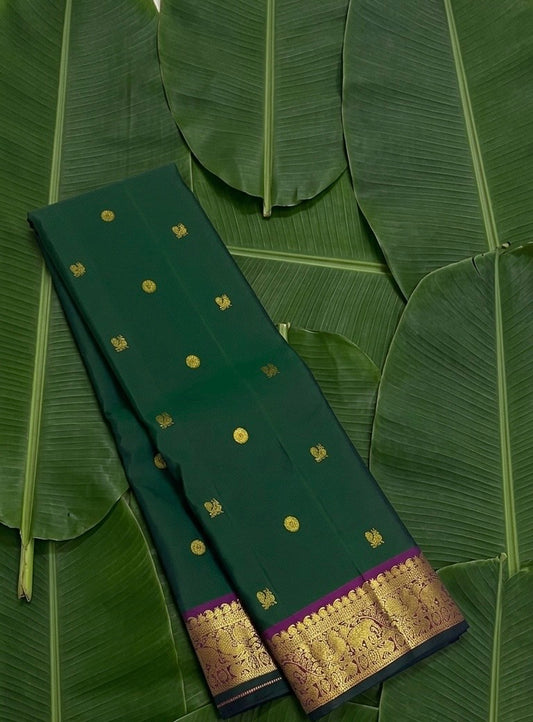 Forest green handwoven Kancheepuram pure silk saree with mayil chakram butta and magenta korvai vanasringaram border — Idam Living