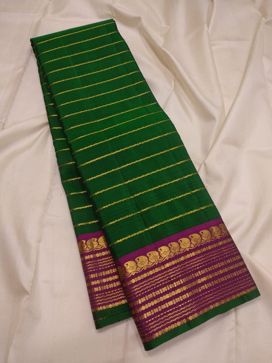 Forest green Kanjivaram Korvai silk saree with Veldhari weave and magenta border — full folded overview