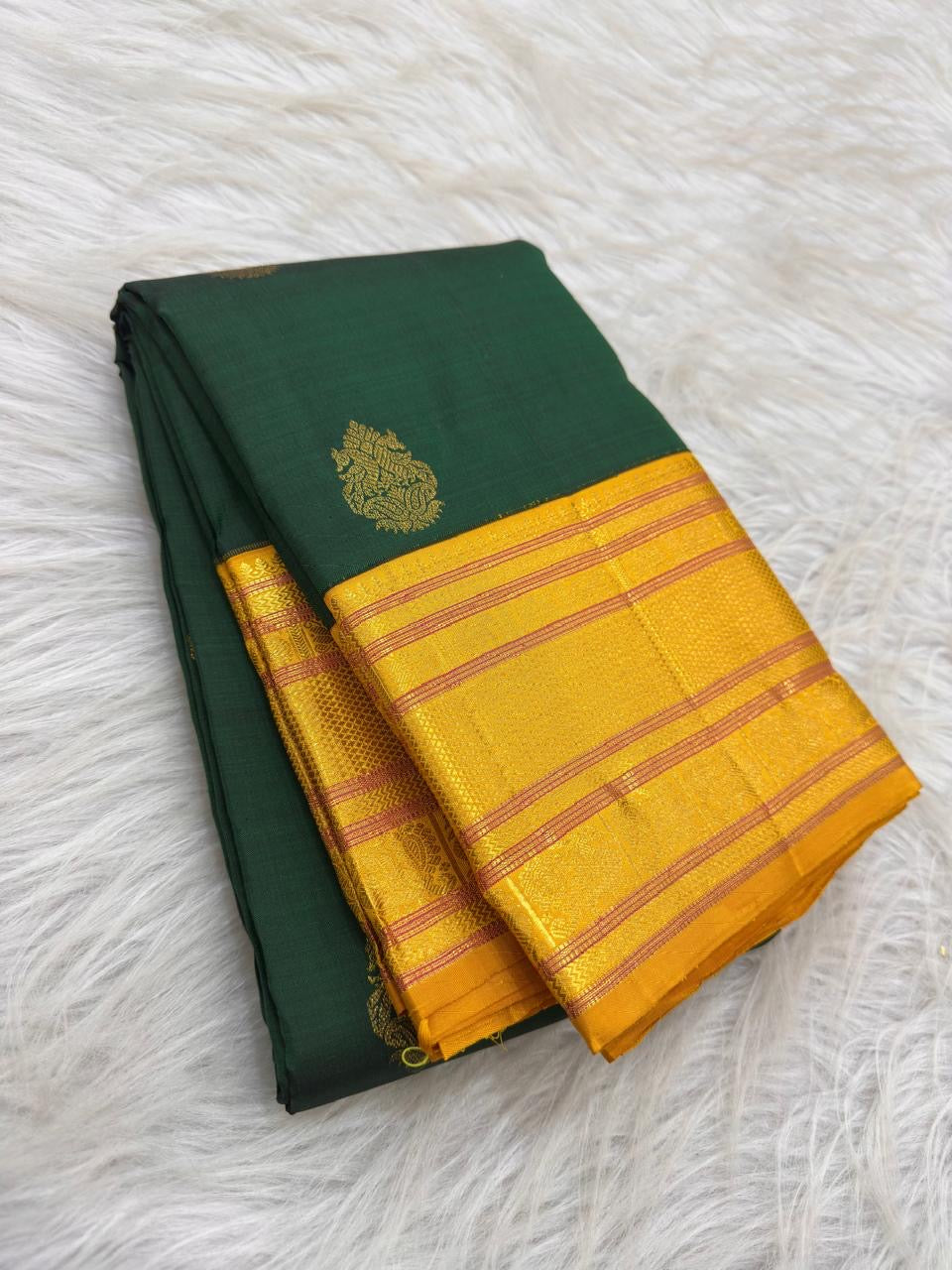 Full view of forest-green Varisaipet silk saree with bright turmeric-yellow zari border