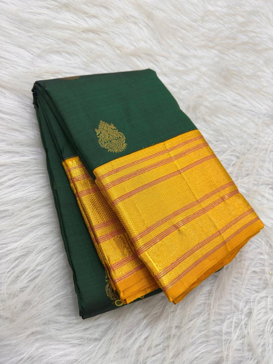 Full view of forest-green Varisaipet silk saree with bright turmeric-yellow zari border