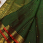 Handwoven Pure Silk Kanchipuram Butta saree with an open dark green body and small gold motifs.