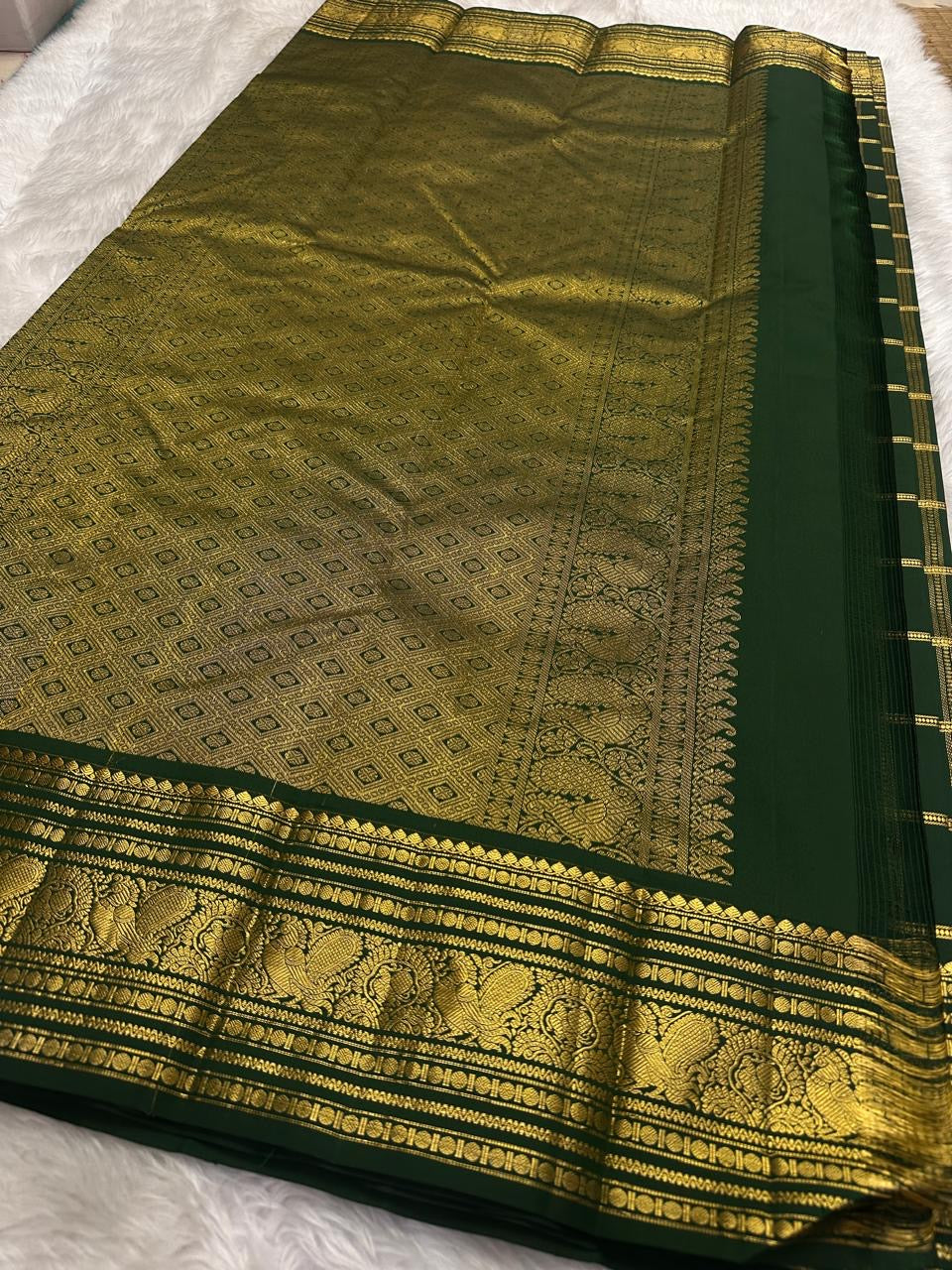Deep Forest Green Pure Silk Kanchi Pattu saree with intricate warm-gold zari detailing