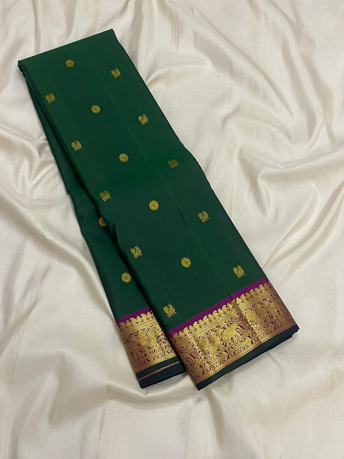 Full view of forest green Kancheepuram pure silk saree with mayil chakram butta and korvai border — Idam Living