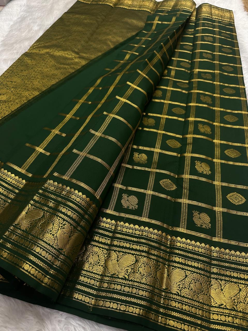 Close view of fine gold Zari Kattam checks on Deep Forest Green Kanchipuram silk