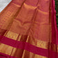 Karum Pachai Pure Silk Kanchipuram contrasted with deep rose-magenta silk and warm traditional gold zari.