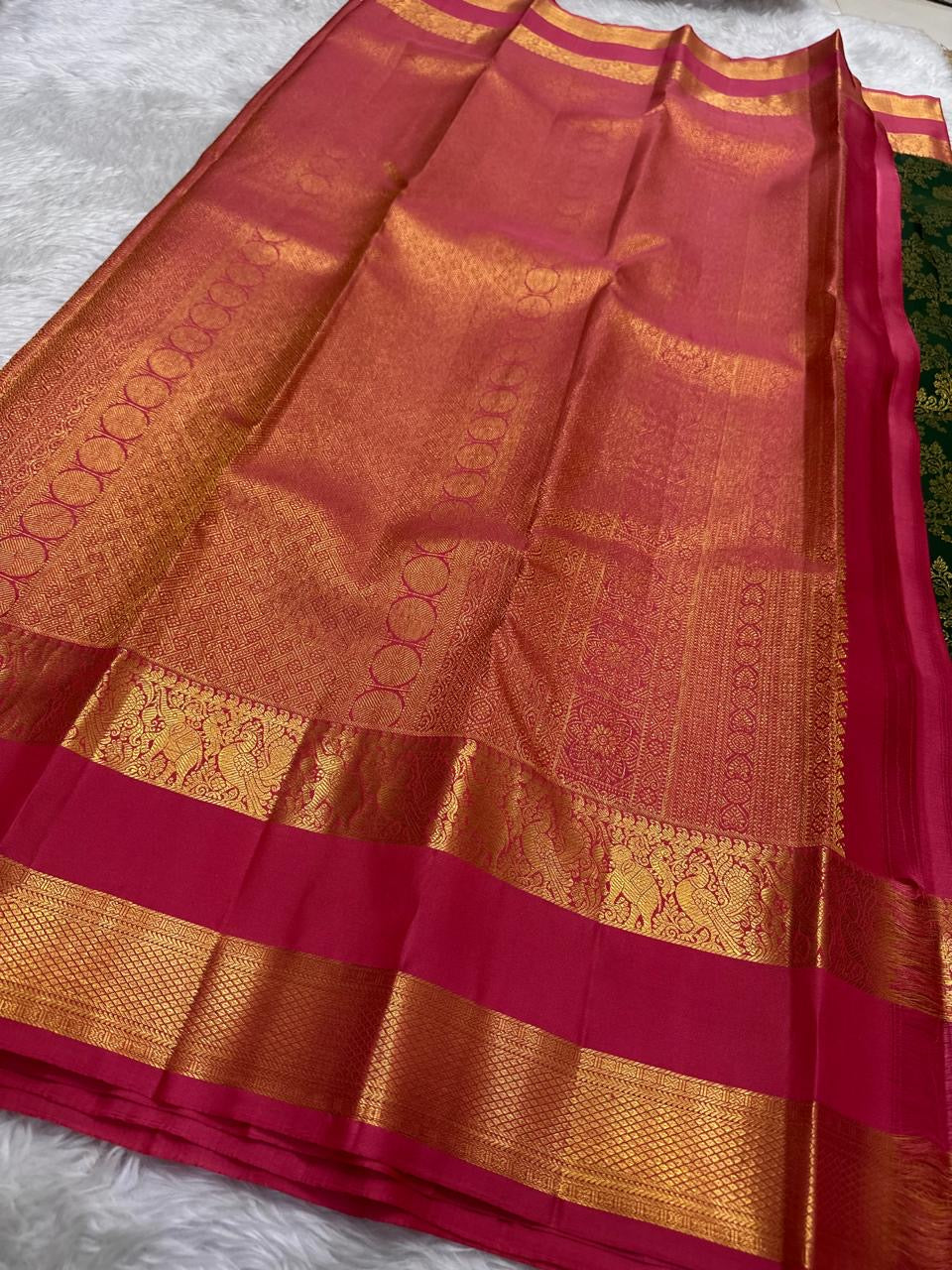 Karum Pachai Pure Silk Kanchipuram contrasted with deep rose-magenta silk and warm traditional gold zari.