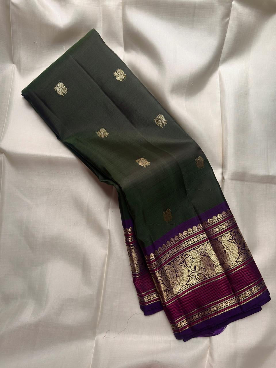 Handwoven Forest Green Kanchipuram silk saree with antique gold zari buttas