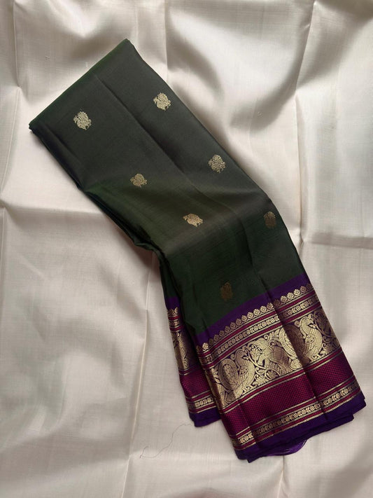 Handwoven Forest Green Kanchipuram silk saree with antique gold zari buttas