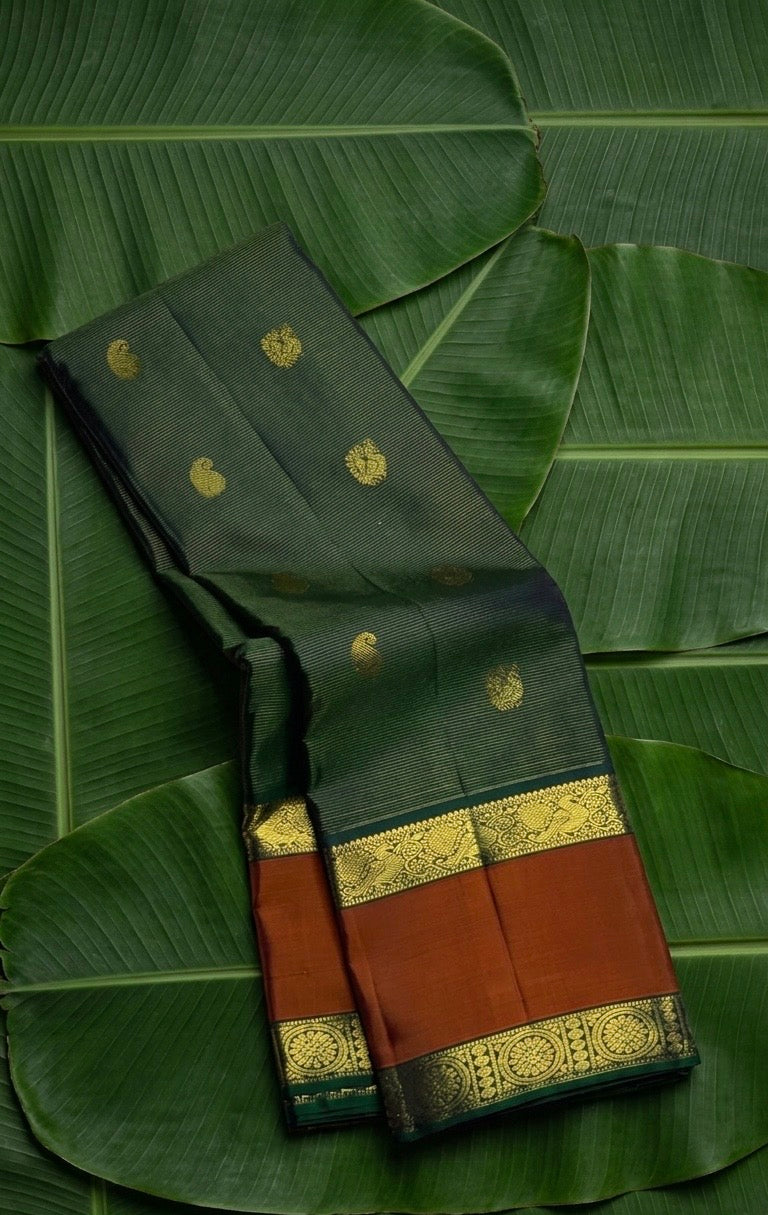 Bottle green and cinnamon terracotta vairaoosi Kanchipuram silk saree with maanga and mayil butta — Idam Living