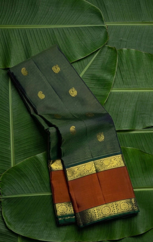 Bottle green and cinnamon terracotta vairaoosi Kanchipuram silk saree with maanga and mayil butta — Idam Living