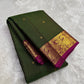 Forest green Kanchipuram saree draped, showing zari kattam checks