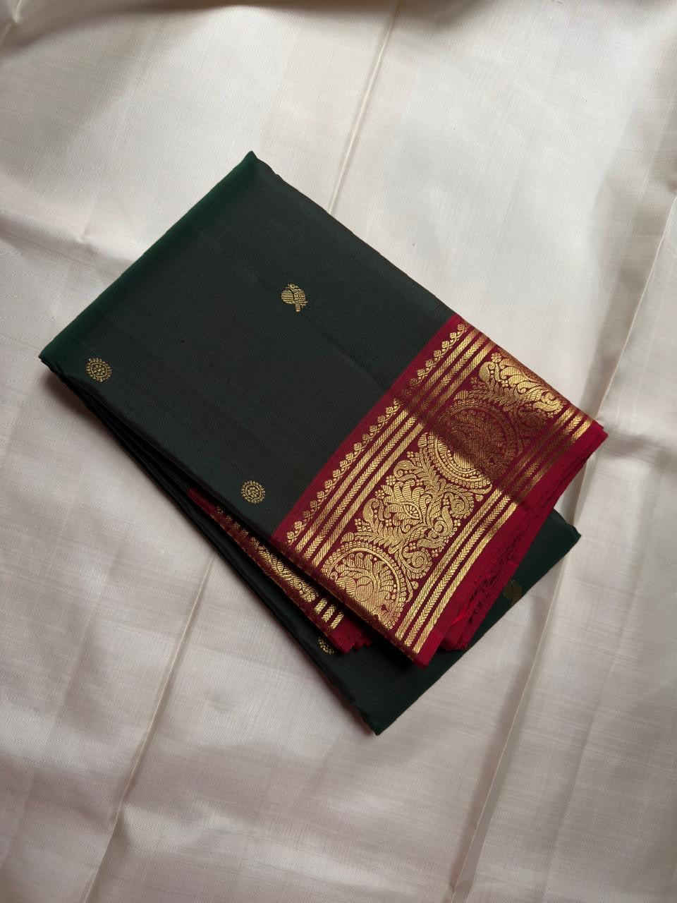 Fresh Forest Green Pure Silk Kanchipuram Butta saree with gold buttas and Deep Arakku Red zari border.