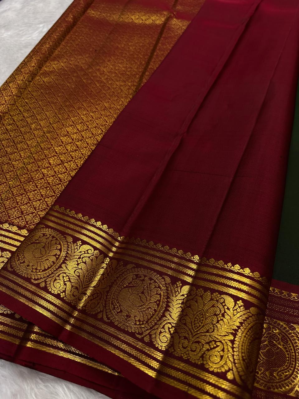 Deep Arakku Red Kanchipuram border with broad traditional classic-gold zari ornamental bands.