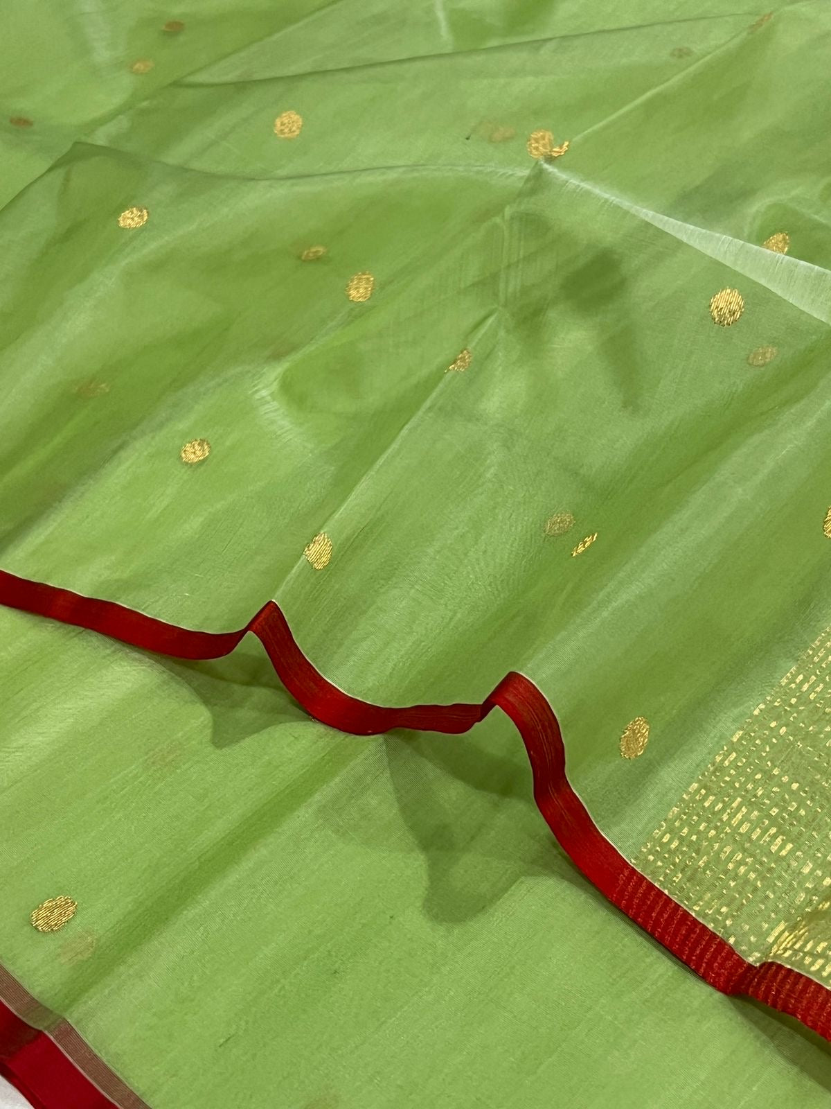 Full view of fresh leaf green Chanderi Katan Silk saree with gold buttas and fine zari pallu