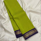 Fresh green Kanchipuram body with deep purple border and repeating gold zari paisley motifs