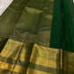 Oosi Vaanam stripes with alternating gold and silver zari buttas on Fresh Leaf Green silk.