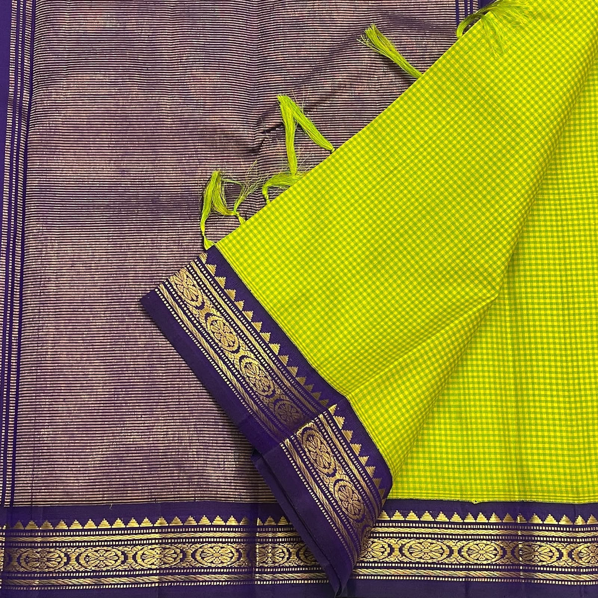 Fine green checked Kanchi Kattam silk body framed by a deep purple traditional zari border