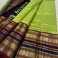 Handwoven fresh green tissue silk Kanchipuram saree with deep violet varisaipet contrast.