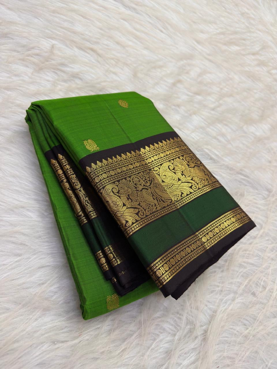 Fresh Leaf Green Kanchipuram body scattered with delicate traditional gold zari buttas.