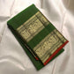 Full spread of fresh leaf green × rust orange Kanchipuram silk showing body, twin zari border and grand pallu arrangement