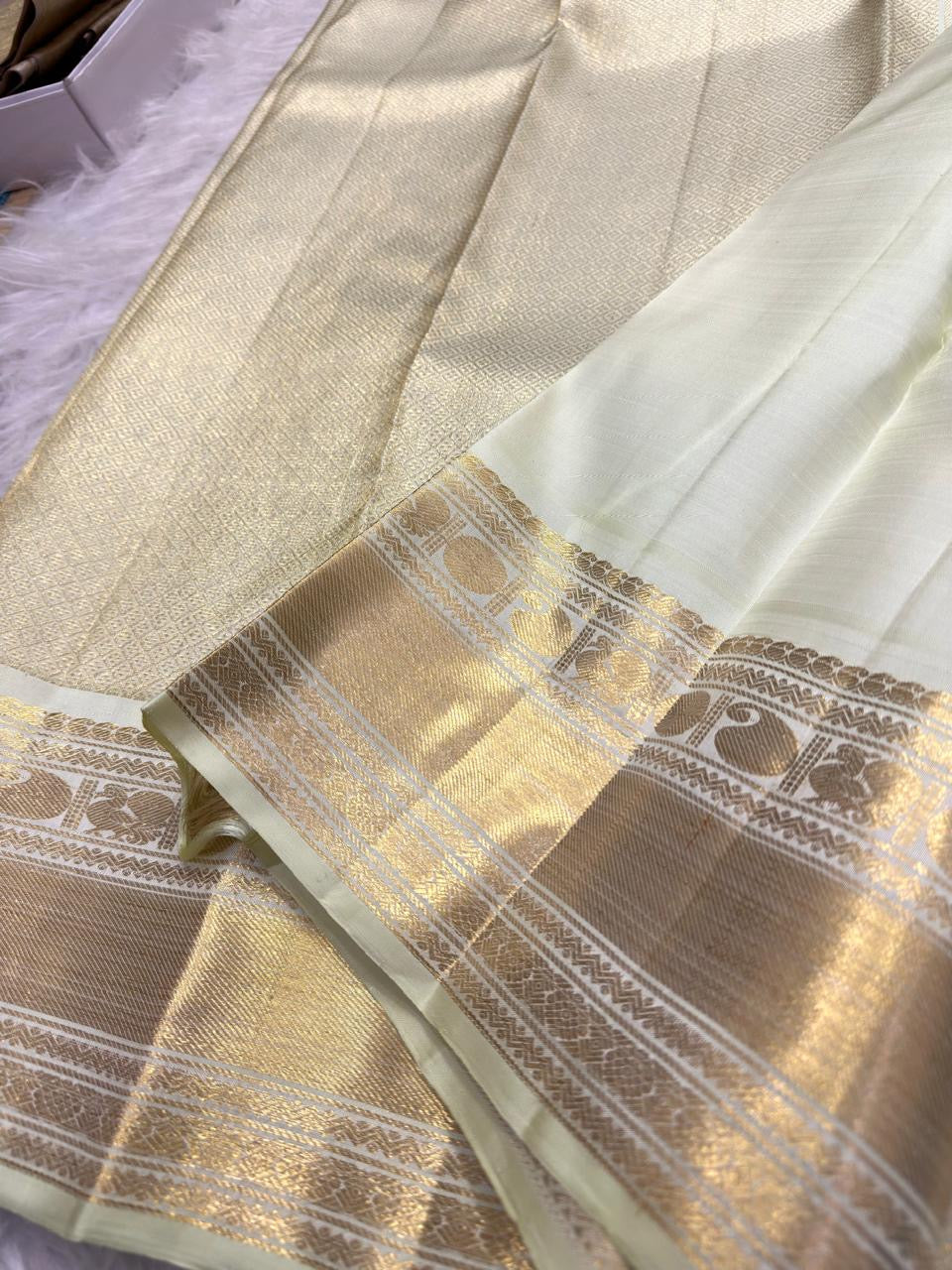 Warm Ivory gold zari Mayil border on green Pure Silk Kanchipuram saree