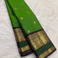 Handwoven Fresh Leaf Green Pure Silk Kanchipuram Butta saree with delicate gold zari buttas.