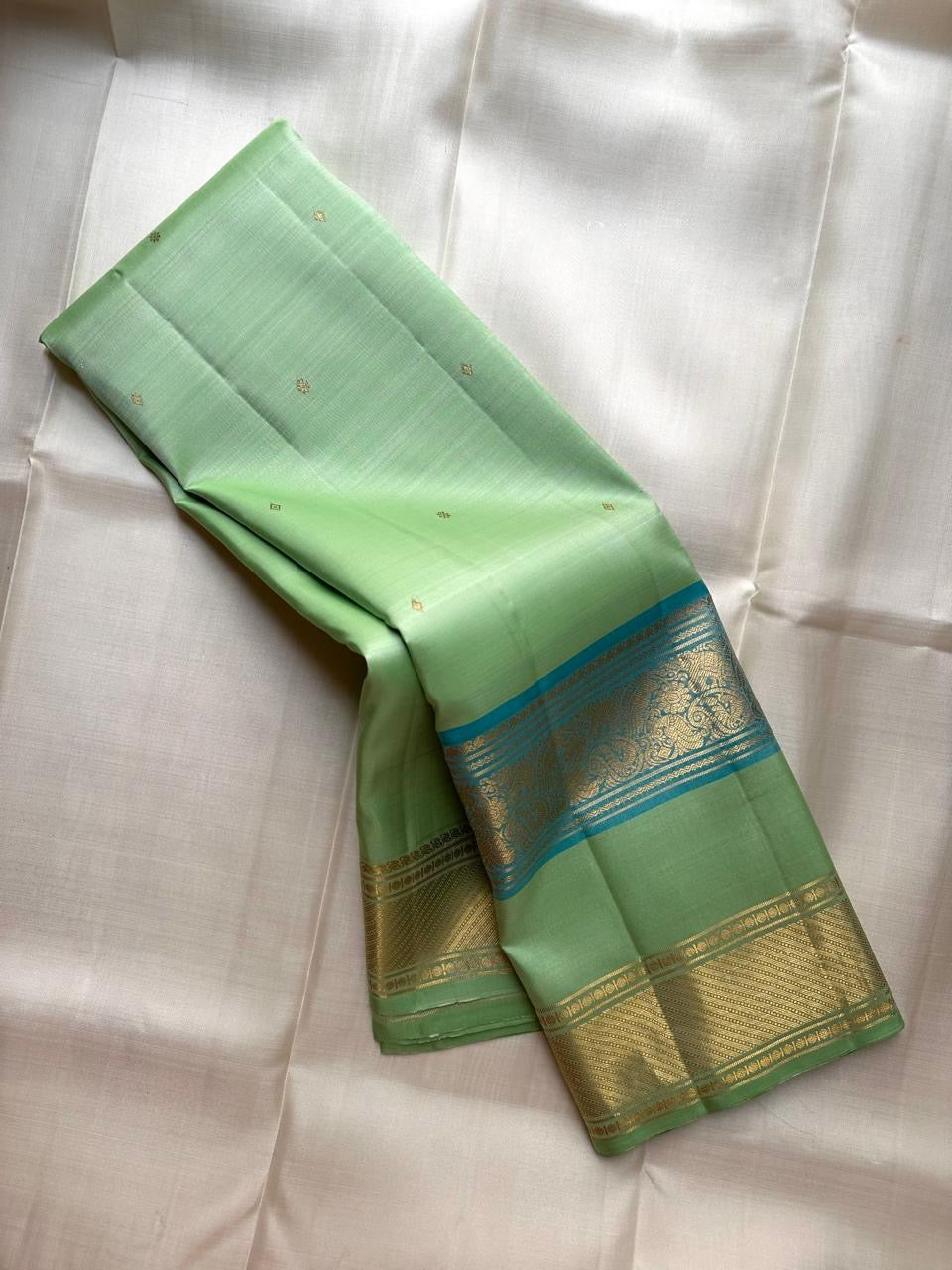 Fresh Pistachio Green Kanchi Pattu silk saree, gold zari butta motif close-up — Idam Living
