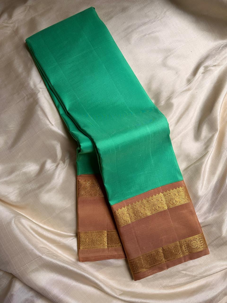 Kanchipattu silk saree in fresh turquoise green with sandal brown border Korvai Rettapet weave traditional zari detail