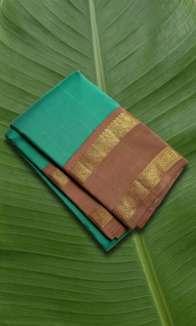 Kanchipuram silk saree in fresh turquoise green with sandal brown border Korvai Rettapet weave folded view