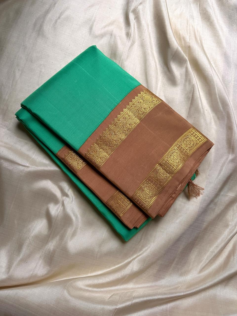 Kanchipattu silk saree in fresh turquoise green with sandal brown border Korvai Rettapet weave traditional zari detail