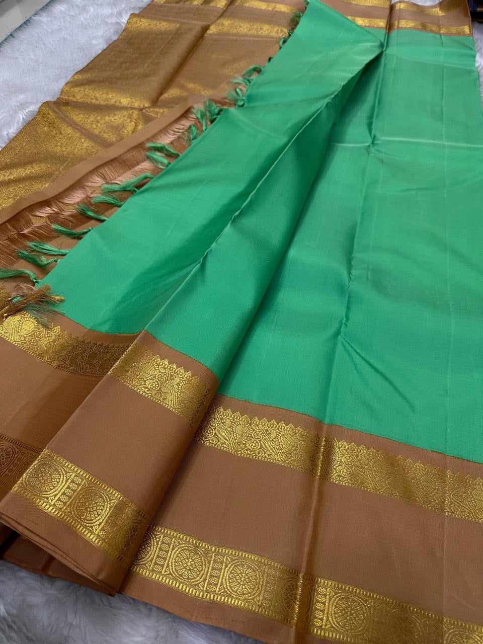 Kanchipattu silk saree in fresh turquoise green with sandal brown border Korvai Rettapet weave traditional zari detail
