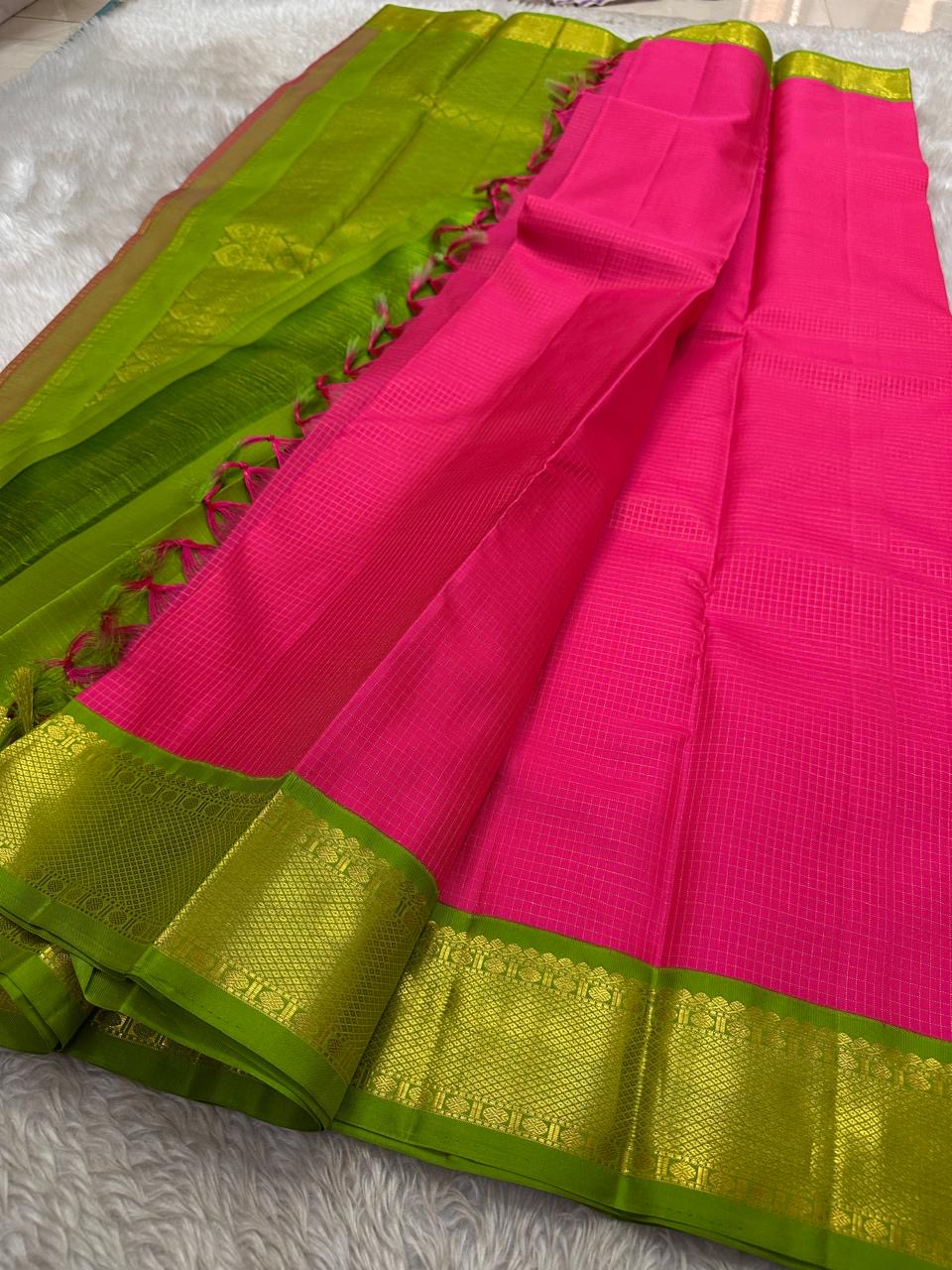Fuchsia pink Kanchipuram saree with Arai Maadam Mayil Kann border