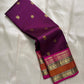 Handwoven pure silk Kanchipuram rettapet saree in fuchsia pink with larger gold buttas and a coffee-brown contrast border.