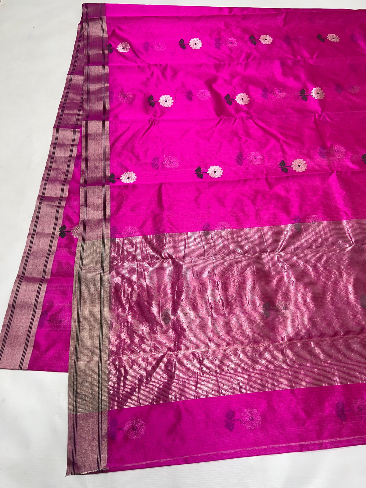 Fuchsia pink Pattu Silk Chanderi saree with small pale flowers and a broad metallic pallu.