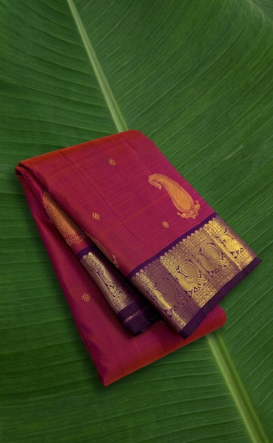 Kanchipuram silk saree in fuchsia pink with royal purple border Korvai Maanga Butta weave folded view