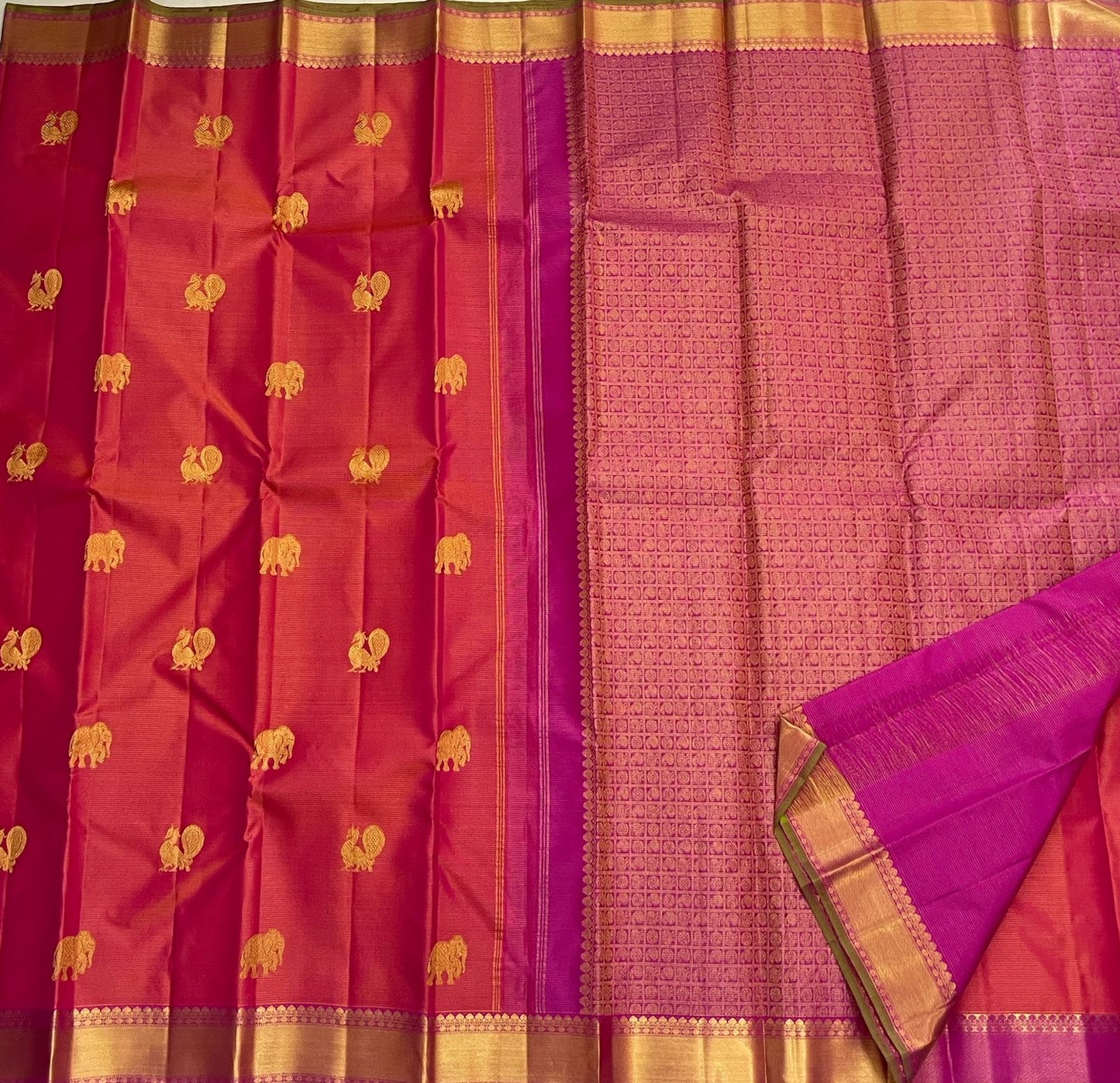 Full flat-lay showing rani pink vairaoosi body with gold buttas and contrasting purple pallu (available in the USA)
