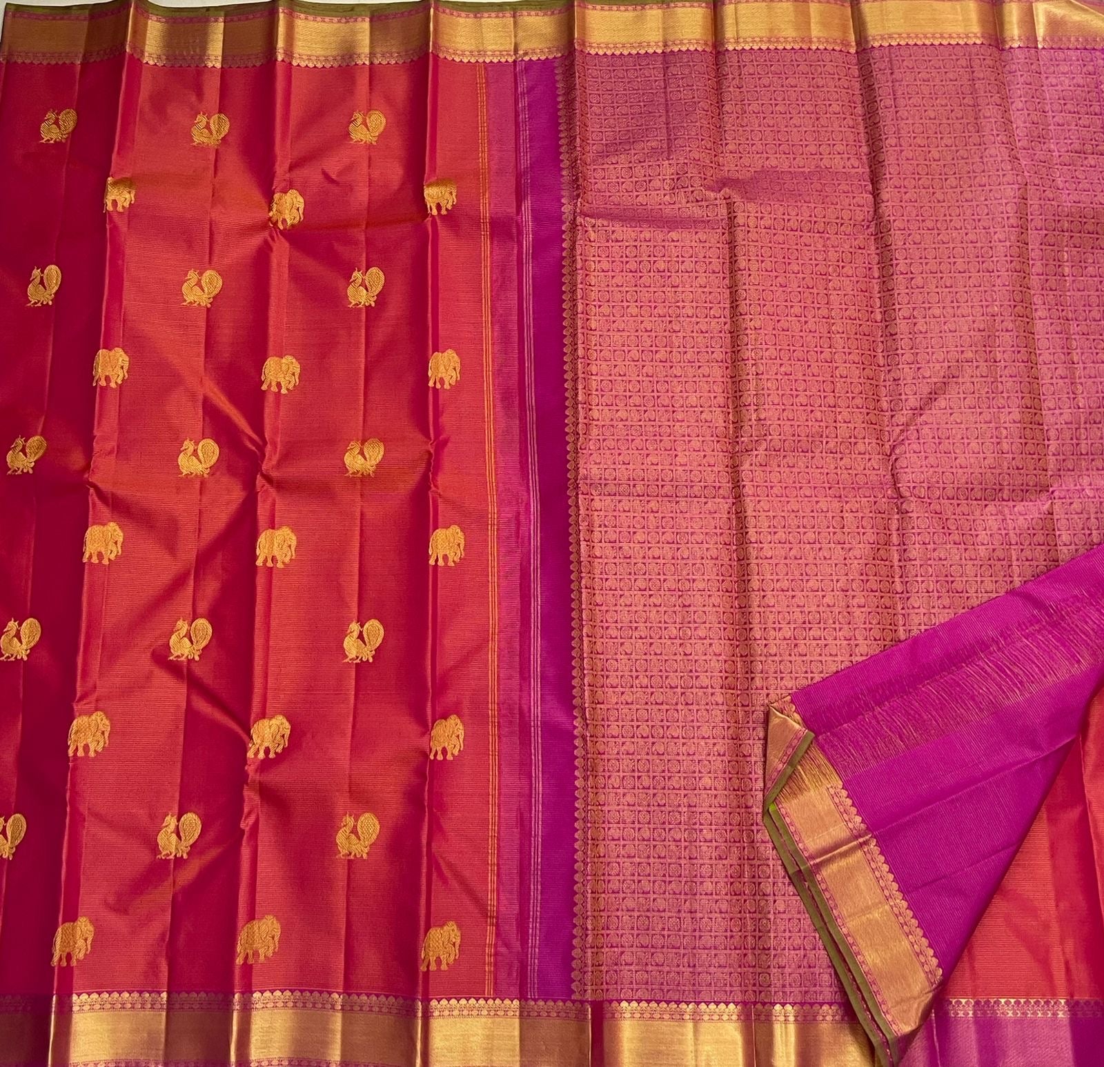 Full flat-lay showing rani pink vairaoosi body with gold buttas and contrasting purple pallu (available in the USA)