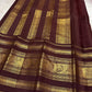 Gold Gandaberunda motifs woven in a repeating arrangement on the olive-green silk body.